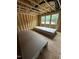Unfinished bedroom featuring exposed wood beams and natural light from multiple windows at 448 Golden Dragonfly St, Wake Forest, NC 27587