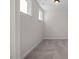 Neutral bedroom with two windows, neutral carpet, white trim, and a ceiling light at 448 Golden Dragonfly St, Wake Forest, NC 27587