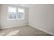An empty bedroom featuring a window and carpeted floors at 448 Golden Dragonfly St, Wake Forest, NC 27587
