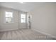 Bright bedroom featuring two windows and neutral carpeting, offering a serene and inviting space at 448 Golden Dragonfly St, Wake Forest, NC 27587
