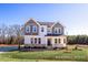 Charming two-story home with a welcoming front porch and well-manicured lawn at 448 Golden Dragonfly St, Wake Forest, NC 27587
