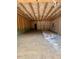 Unfinished garage featuring exposed beams and natural light from multiple windows at 448 Golden Dragonfly St, Wake Forest, NC 27587