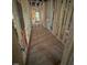 Unfinished hallway featuring exposed wood beams and natural light from multiple windows at 448 Golden Dragonfly St, Wake Forest, NC 27587