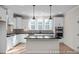 Modern kitchen with white cabinetry, black countertops, and stainless steel appliances at 448 Golden Dragonfly St, Wake Forest, NC 27587