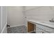 Well-organized laundry room with stylish patterned floors, ample counter space, and functional shelving at 448 Golden Dragonfly St, Wake Forest, NC 27587