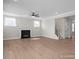 Bright and airy living room featuring a fireplace, wood-look flooring, and a staircase at 448 Golden Dragonfly St, Wake Forest, NC 27587