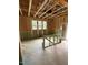 Unfinished living room featuring exposed wood beams and natural light from multiple windows at 448 Golden Dragonfly St, Wake Forest, NC 27587