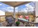 Back porch with ample seating, stylish rugs, and a serene view at 456 Golden Dragonfly St, Wake Forest, NC 27587
