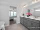 Well-lit bathroom featuring dual sinks, a bathtub, and doorway to bedroom at 456 Golden Dragonfly St, Wake Forest, NC 27587