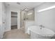 Bright bathroom with a soaking tub and glass-enclosed shower at 456 Golden Dragonfly St, Wake Forest, NC 27587