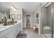 Elegant bathroom featuring dual vanities, tiled floors, and a walk-in shower at 456 Golden Dragonfly St, Wake Forest, NC 27587