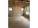 Unfinished bedroom featuring insulation, exposed framing, and windows to the outside at 456 Golden Dragonfly St, Wake Forest, NC 27587