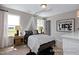 Well-lit bedroom with natural wood nightstands and a playful 'Glamping Life' sign at 456 Golden Dragonfly St, Wake Forest, NC 27587