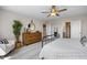 Cozy bedroom with neutral tones, ceiling fan, dresser and view of the bathroom at 456 Golden Dragonfly St, Wake Forest, NC 27587