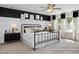 Stylish bedroom with black accent wall, decorative headboard, and natural light at 456 Golden Dragonfly St, Wake Forest, NC 27587