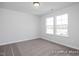 Bedroom with neutral carpet, two windows letting in natural light, and fresh white paint at 456 Golden Dragonfly St, Wake Forest, NC 27587