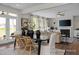 Open-concept dining area with large windows, a modern fireplace, and a seamless transition to the living room at 456 Golden Dragonfly St, Wake Forest, NC 27587