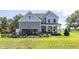 Charming two-story home with gray siding, inviting porch, and well-maintained lawn and black aluminum fence at 456 Golden Dragonfly St, Wake Forest, NC 27587