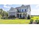 Inviting two-story home with gray siding, classic white trim, and a welcoming front porch at 456 Golden Dragonfly St, Wake Forest, NC 27587