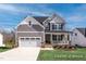 Charming two-story home with gray siding, stone accents, and a welcoming front porch at 456 Golden Dragonfly St, Wake Forest, NC 27587