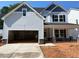 Charming two-story home featuring a spacious two-car garage, stone accents, and a covered front porch at 456 Golden Dragonfly St, Wake Forest, NC 27587