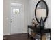 A lovely front entry with a black accent table, basket storage, and a charming mirror and entry door at 456 Golden Dragonfly St, Wake Forest, NC 27587