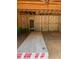 Unfinished garage interior showing exposed framing, insulation, and new materials ready to be installed at 456 Golden Dragonfly St, Wake Forest, NC 27587