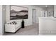 Cozy hallway nook with a comfortable chair, decorative artwork, and easy access to rooms at 456 Golden Dragonfly St, Wake Forest, NC 27587