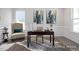 Well-lit home office with a desk, artwork, and a comfortable chair, perfect for productivity at 456 Golden Dragonfly St, Wake Forest, NC 27587