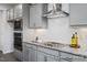 Modern kitchen features stainless steel appliances, granite countertops, gray cabinets, and white subway tile backsplash at 456 Golden Dragonfly St, Wake Forest, NC 27587