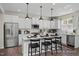 Contemporary kitchen with white cabinets, stainless steel appliances, and a spacious center island with barstool seating at 456 Golden Dragonfly St, Wake Forest, NC 27587