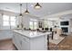 Open concept kitchen with island and seating, and the view to the living room at 456 Golden Dragonfly St, Wake Forest, NC 27587