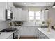 Bright kitchen featuring an island, white cabinetry, stainless steel appliances, and subway tile backsplash at 456 Golden Dragonfly St, Wake Forest, NC 27587
