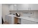 Functional laundry room with modern appliances, white cabinets, and a sink at 456 Golden Dragonfly St, Wake Forest, NC 27587