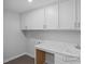 Laundry room with white cabinets, light countertop, stainless sink and washer/dryer hookups at 456 Golden Dragonfly St, Wake Forest, NC 27587