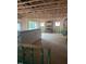 Exposed framing and insulation of the unfinished living room features windows for natural light at 456 Golden Dragonfly St, Wake Forest, NC 27587
