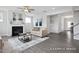 Open-concept living room with a fireplace, sofa, and seamless access to other living areas at 456 Golden Dragonfly St, Wake Forest, NC 27587