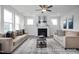 Bright living room with a fireplace, ceiling fan, and comfortable seating for relaxation at 456 Golden Dragonfly St, Wake Forest, NC 27587