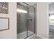 Modern tiled shower with glass enclosure and bench seating at 456 Golden Dragonfly St, Wake Forest, NC 27587