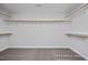 Spacious walk-in closet with ample shelving and carpeted floor at 456 Golden Dragonfly St, Wake Forest, NC 27587