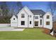 Stunning new construction home featuring a modern farmhouse design, lush lawn, and separate garage at 459 Windfall Creek Dr, Chapel Hill, NC 27517