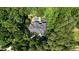 Aerial view of beautiful estate with a swimming pool surrounded by a lush green forest at 4817 Fox Branch Ct, Raleigh, NC 27614
