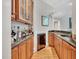 Close-up of a bar area, featuring wood cabinets with stone counters and wine fridge at 4817 Fox Branch Ct, Raleigh, NC 27614