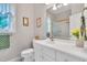 Well-lit bathroom featuring a vanity with white cabinets, a toilet, and a shower with a gold frame at 4817 Fox Branch Ct, Raleigh, NC 27614