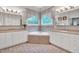 Bright bathroom with a corner soaking tub, dual sinks, and tile flooring, creating a spa-like retreat at 4817 Fox Branch Ct, Raleigh, NC 27614