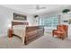 Bedroom featuring a decorative bed frame, neutral walls, and a comfortable sitting area at 4817 Fox Branch Ct, Raleigh, NC 27614