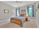 Cozy bedroom with natural light, neutral walls, ceiling fan and an adjoining bathroom at 4817 Fox Branch Ct, Raleigh, NC 27614