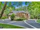 Stately brick home with a circular driveway surrounded by mature trees offering privacy and curb appeal at 4817 Fox Branch Ct, Raleigh, NC 27614