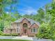 Beautiful brick two-story home with landscaped front yard, large windows and a circular driveway at 4817 Fox Branch Ct, Raleigh, NC 27614