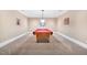 Finished game room with a beautiful red pool table, neutral walls, and carpeted floors at 4817 Fox Branch Ct, Raleigh, NC 27614
